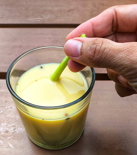 istock a man's hand stirring a ginger herbal drink using lemongrass stalks 2188740612