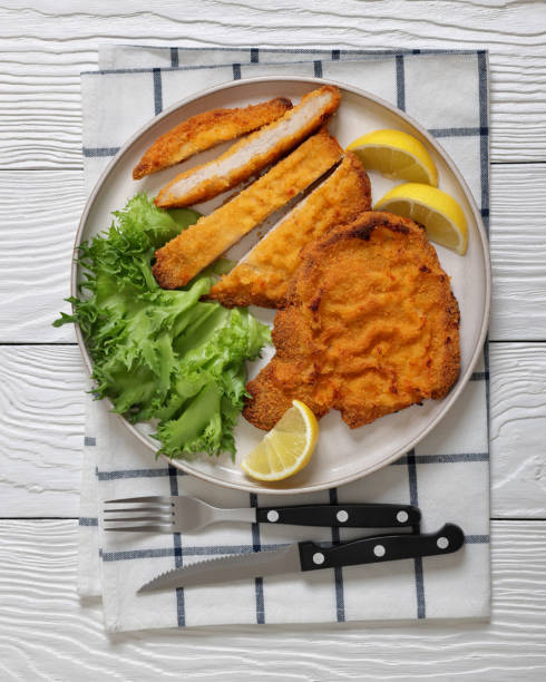 istock Pork Milanese with lettuce and lemon on a plate 2188741277