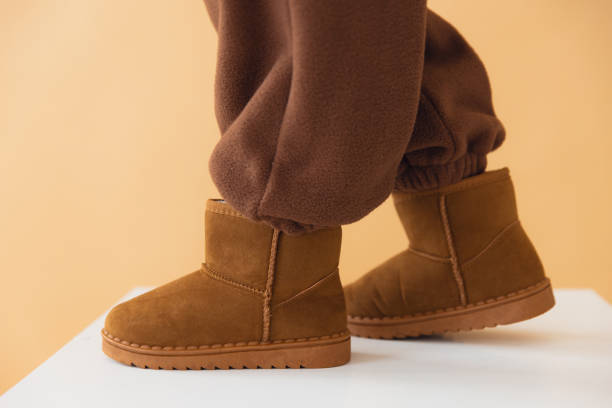 istock Comfortable suede boots and brown pants mockup on beige background 2188741301