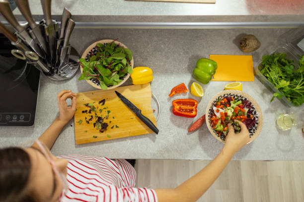 istock Girl with vegetables at kitchen 2188742820