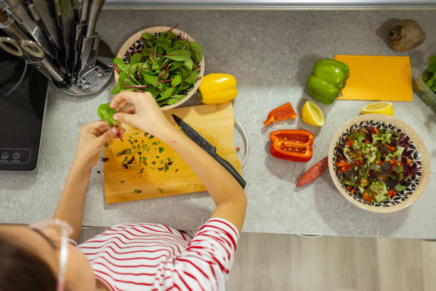 istock Girl with vegetables at kitchen 2188743088