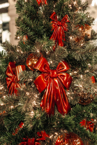 istock Christmas tree decorated with red bright bows with ribbons, indoor festive decor 2188744595
