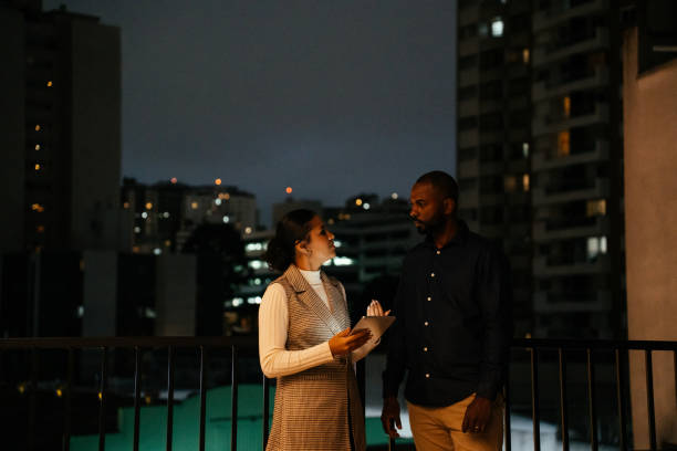 istock Two employees looking at tablet at night on the terrace 2188745723