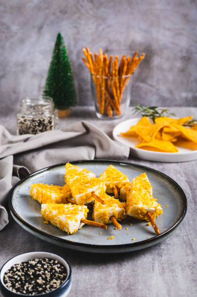 istock Fake Christmas trees made from triangle cheese in nacho crumbles on a plate vertical view 2188752440