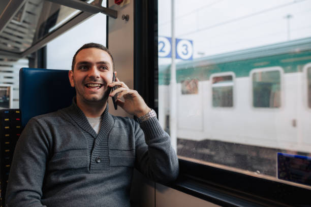istock Young Man Using Smartphone While Traveling on Train for Business 2188755276