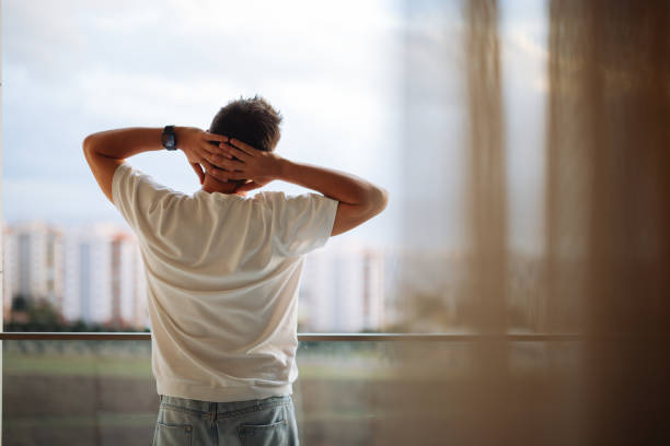 istock Bearded man looking out over the city at sunrise 2188756318