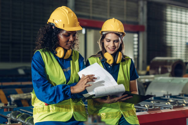 istock Foreman or worker work at factory site check up machine or products in site. 2188757303