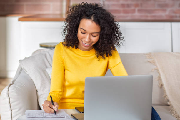 istock Smiling Woman Writing and Working at Home 2188758069