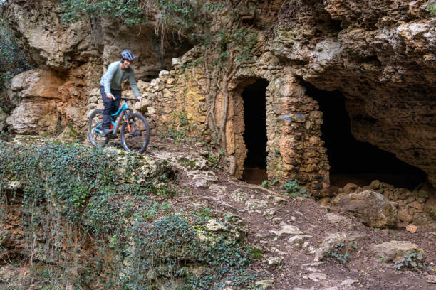 istock Mature woman e-bikes near ancient ruins in forest 2188760376