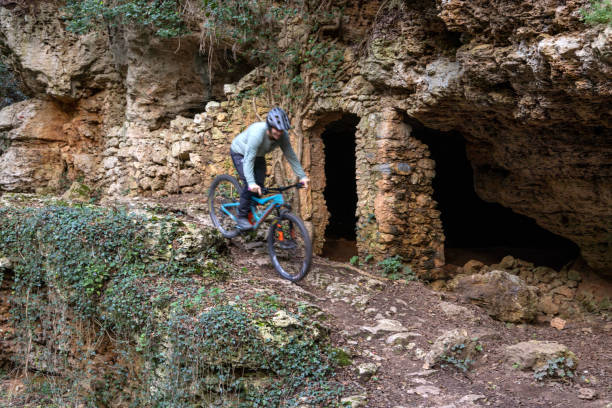 istock Mature woman e-bikes near ancient ruins in forest 2188760430