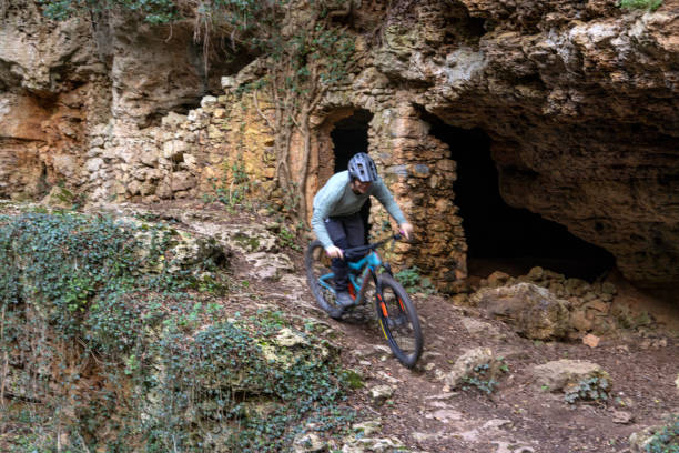 istock Mature woman e-bikes near ancient ruins in forest 2188760431