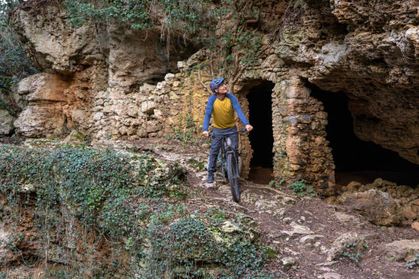 istock Mature man e-bikes to old ruin in forest 2188760628