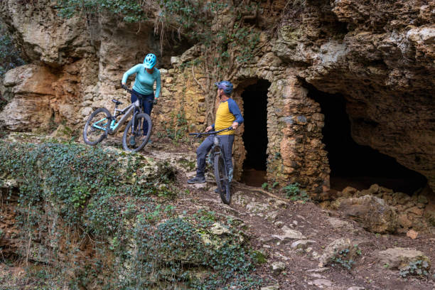 istock Mature couple with e-bikes pause beside ancient ruin 2188760697