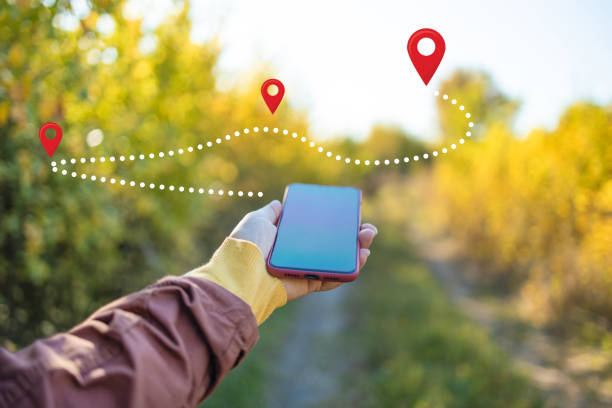 istock Navigation smartphone pathway. Woman standing in middle of forest, using navigation app on smartphone, following route with help of map, looking at device screen, using smartphone navigation while losing yourself in forest 2188762005