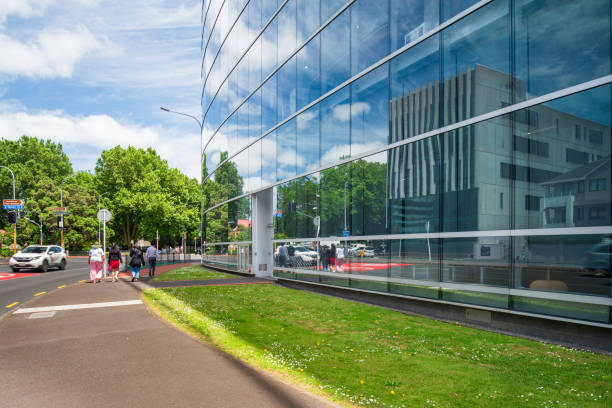 Asphalt road near glass office building.