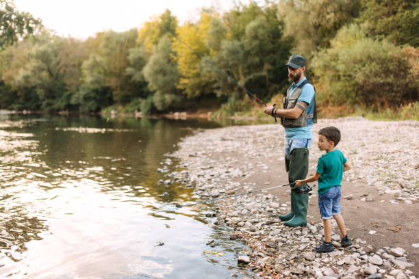 istock Father and son fishing together 2188771071