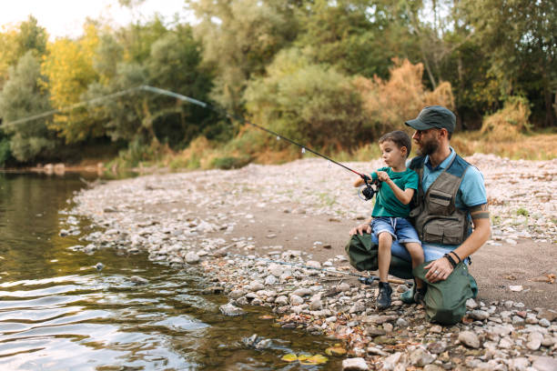 istock Father and son fishing together 2188771089