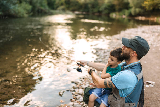 istock Father and son fishing together 2188771097