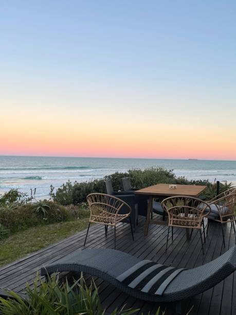 istock Relaxing beachside table with chairs at sunset for tranquil evenings 2188777326