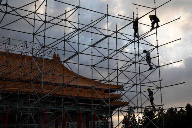On OCT 14th 2024, in Taipei city, Taiwan, Construction workers work on scaffolding at Liberty Square in Taipei City, many of whom are foreign workers from Southeast Asian countries. Taiwan has become the preferred destination for many South Asian and Southeast Asian husbands due to its developed economy and convenient transportation.
