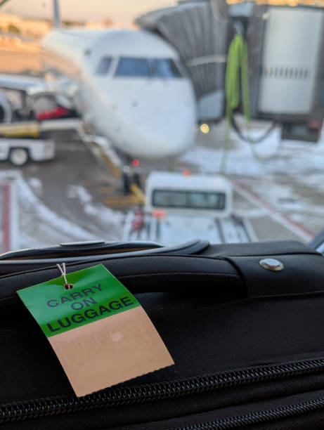 istock Gate check luggage tag on a roller suitcase in an airport. 2188781114