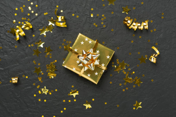 istock Golden gift boxes and confetti on concrete background, top view 2188782851