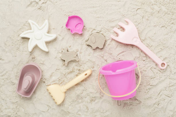 istock Cute toys for playing on sand background, top view 2188782855