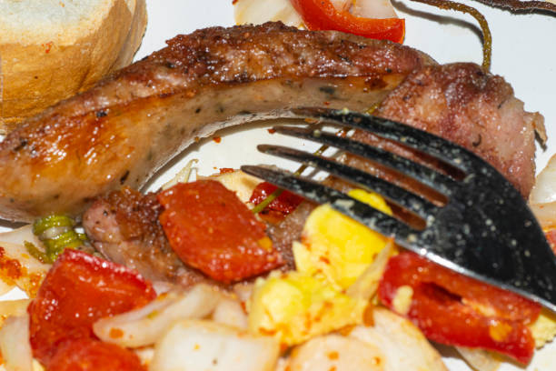 Choripan with creole sauce , on a white plate