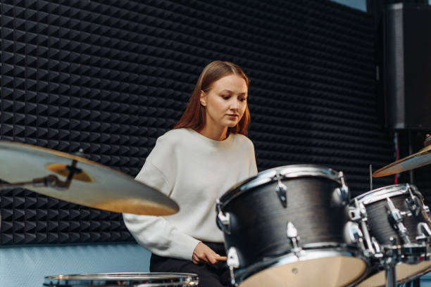 istock young woman playing drum set 2188787638