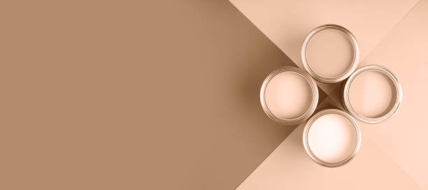 istock Four paint cans arranged on a geometric surface in neutral tones 2188790526