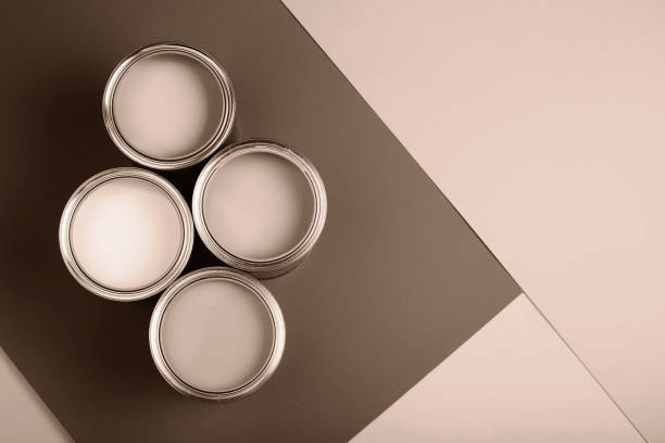 istock Four paint cans on a brown and beige background in soft lighting 2188790539