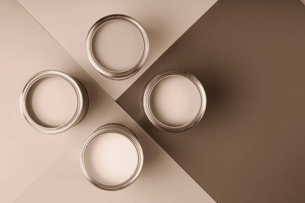 istock Four open paint cans on a brown and cream geometric background 2188790540