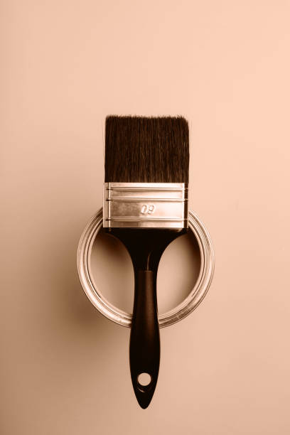 istock A paintbrush with a can lid on a monochromatic background 2188790543