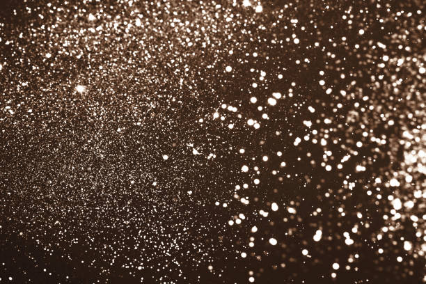 Abstract shimmering background with glowing sparkles and bright lights