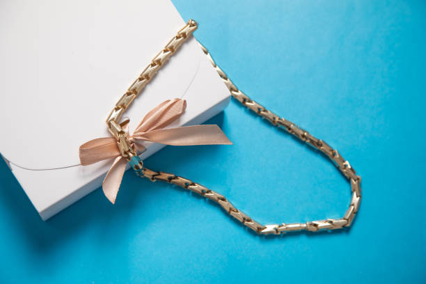 istock Gift box with a gold necklace on the blue background. 2188792987