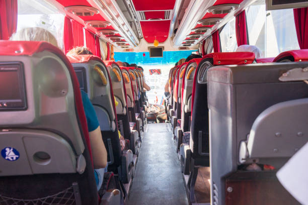 istock View from back seat in a bus. People sitting in a coach. Public transportation concept with summer vibe. 2188798514