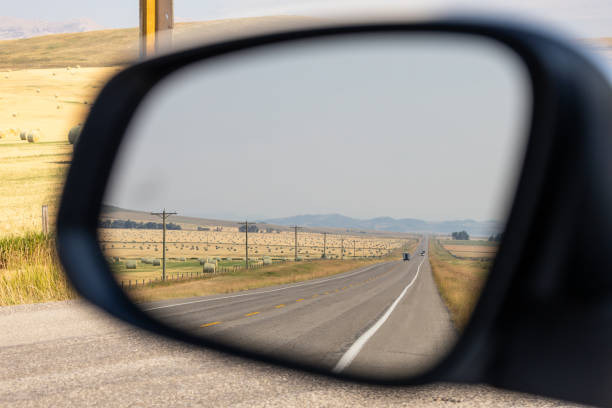 istock Scenic Alberta Road in Car Mirror Reflection 2188805603