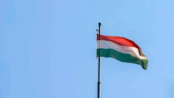 istock Hungarian flag waving on high pole with clear Budapest sky 2188807159
