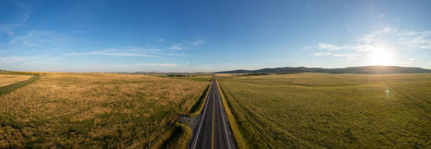 istock Scenic Alberta Highway Crossing Vast Praries Under Clear Blue Sky 2188809654