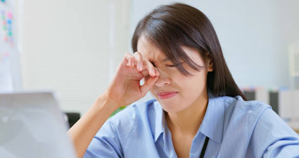 woman eyes pain at work