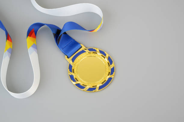 Metal medal with laurel leaves represents the honor of winning.