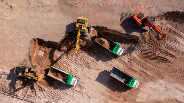 istock Aerial view road motor grader flatting dirt road surface, Motor grader road construction grader industrial machine construction site new road, Aerial view group excavator working on construction site. 2188815843