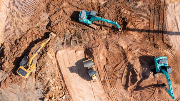 istock Aerial view road motor grader flatting dirt road surface, Motor grader road construction grader industrial machine construction site new road, Aerial view group excavator working on construction site. 2188815862