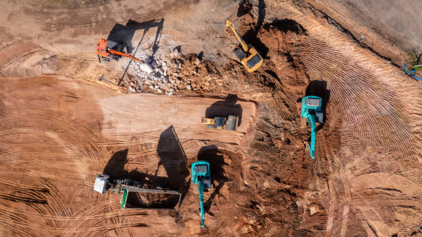 istock Aerial view road motor grader flatting dirt road surface, Motor grader road construction grader industrial machine construction site new road, Aerial view group excavator working on construction site. 2188815884