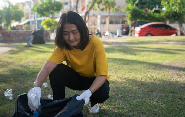 istock Asian woman picking plastic bottle into trash plastic bag black clean up ecology environmental ecology concept 2188817486