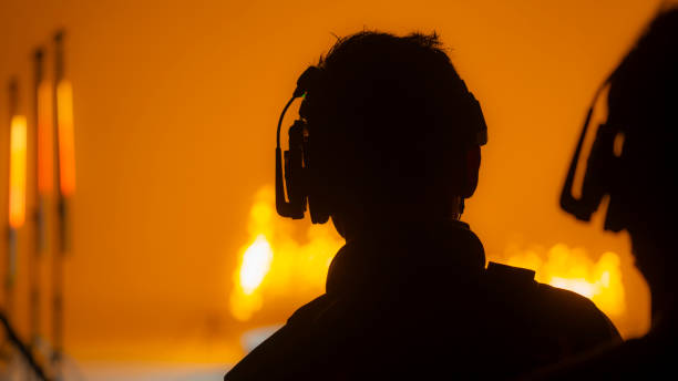 Silhouette of a film or television crew with intercom system in a studio.