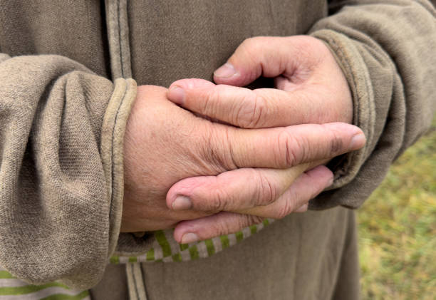 istock A person is wearing a brown jacket and has their hands clasped 2188819089