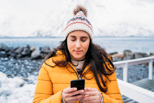 istock Tourist using smartphone in lofoten islands, norway, during winter 2188819450