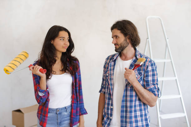 istock Focused Couple with Paint Supplies Planning DIY Home Makeover 2188820045