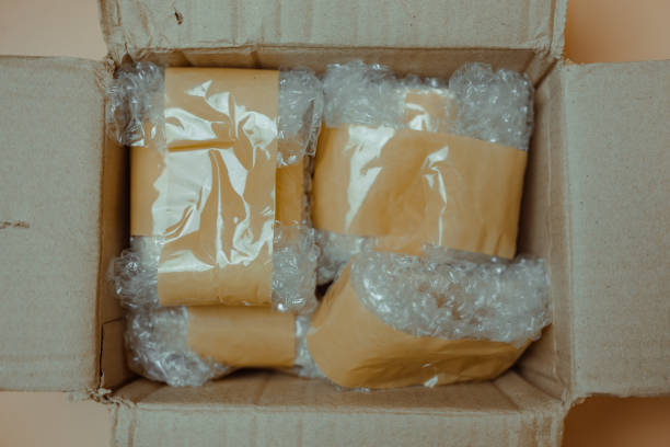 istock Package wrapped in white bubble pack and brown adhesive tape. 2188821815
